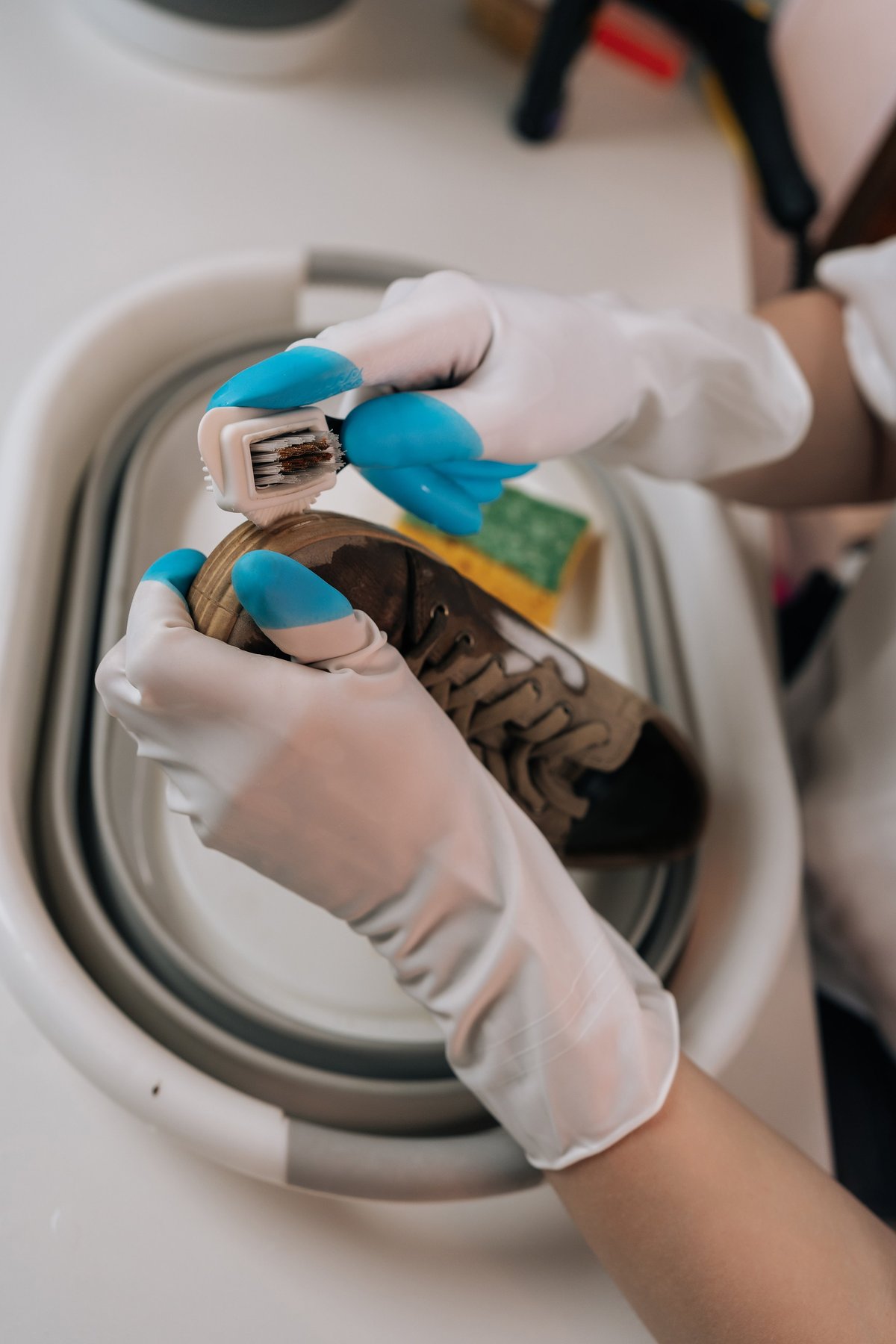 Close-up of a sneaker sole being scrubbed with a small brush